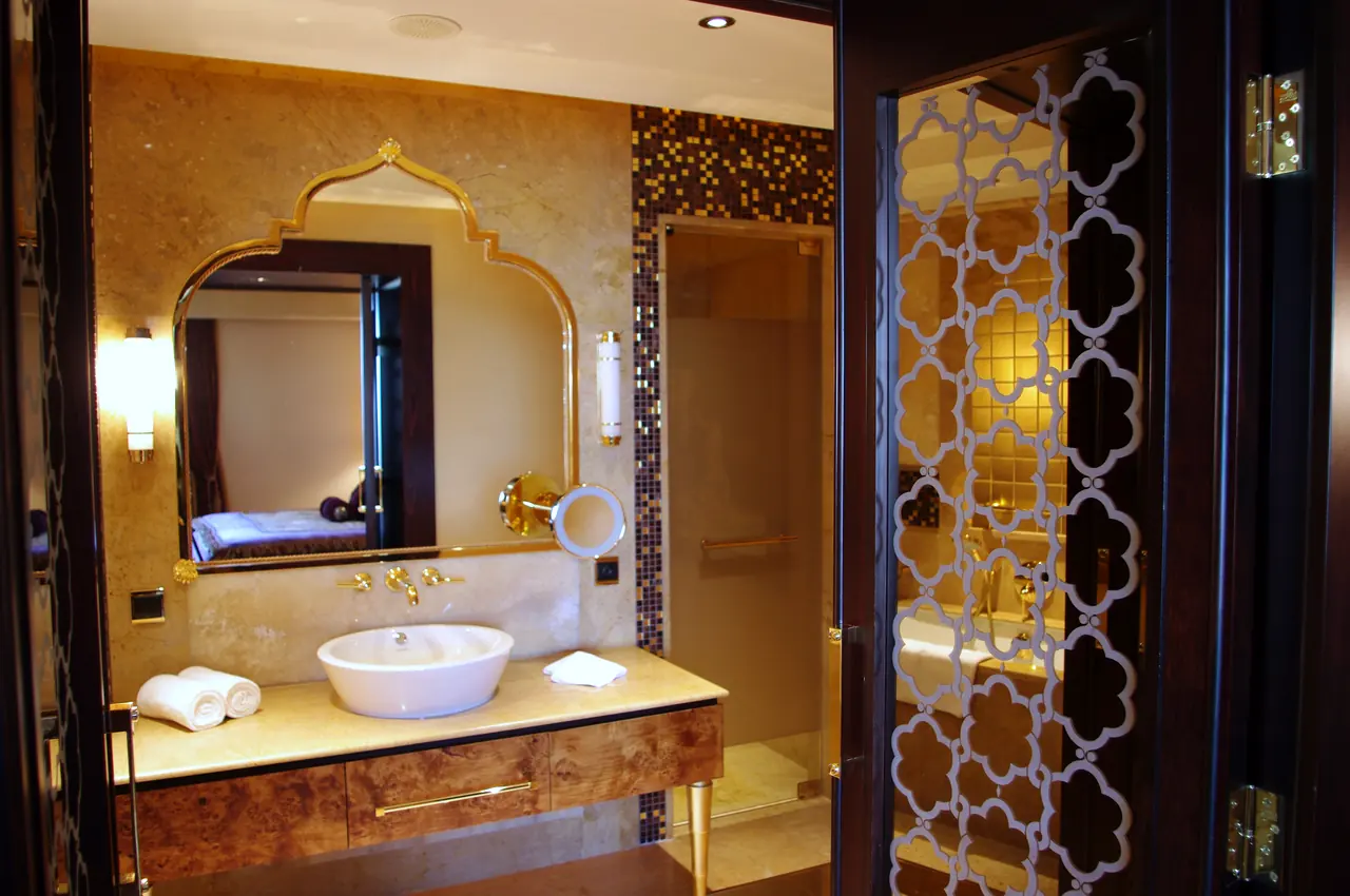 Mardan Palace — Banyo: kemerli ayna ve oyma desenli kapı