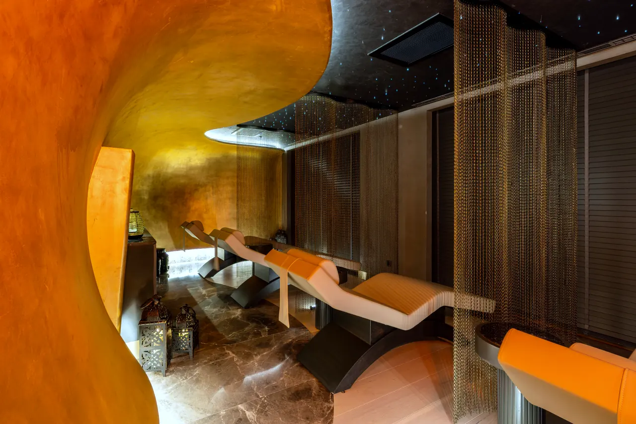 Merit Starlit Hotel Residence — Spa: kavisli turuncu duvar ve dinlenme şezlongları