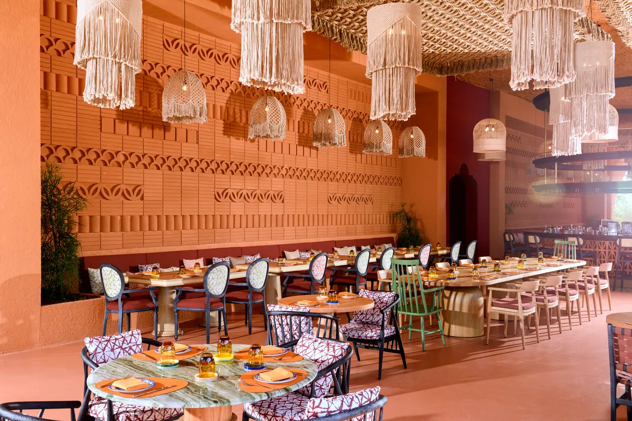 Regnum The Crown · Restoran — Desenli duvar boyunca yuvarlak ve uzun masalar