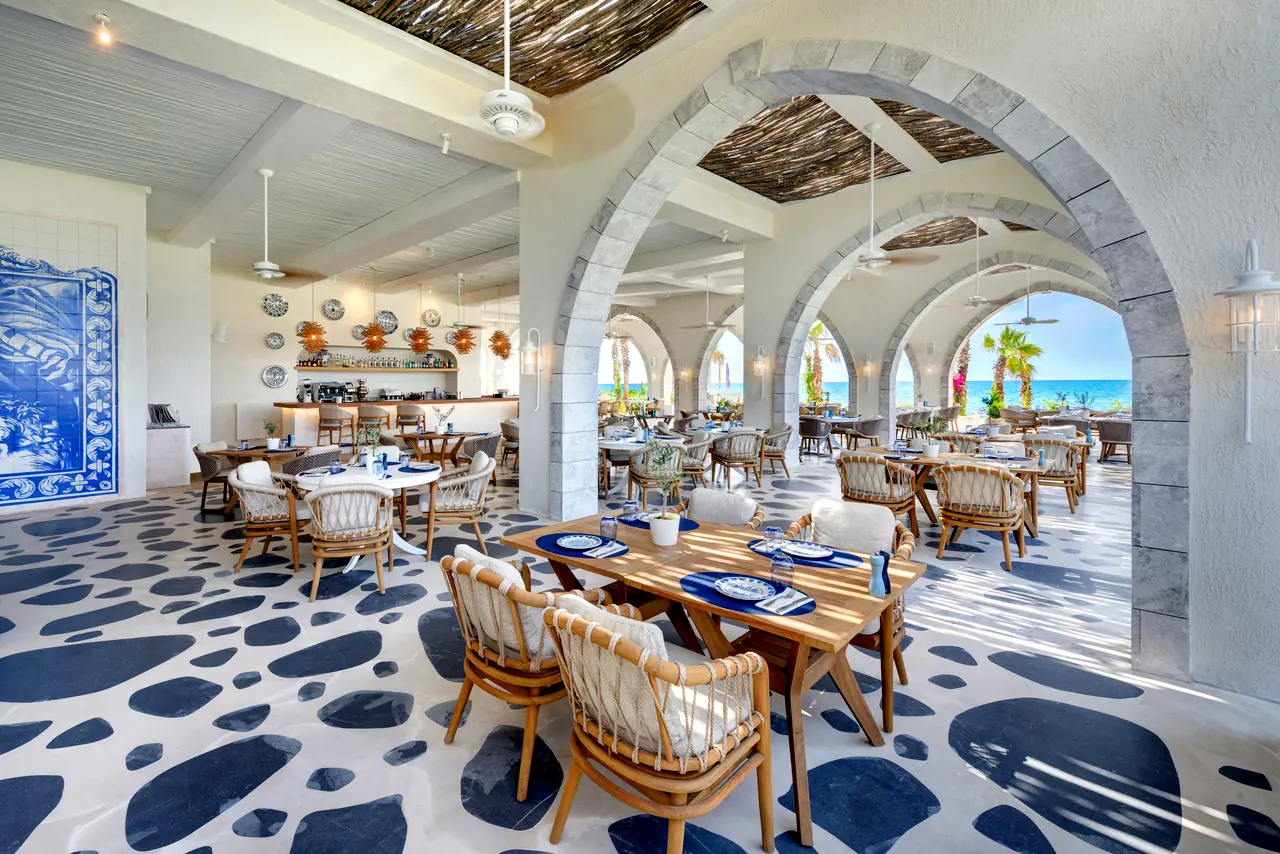 Regnum The Crown · Restoran — Nikos: beyaz kemerler ve lacivert-beyaz taş desenli zemin