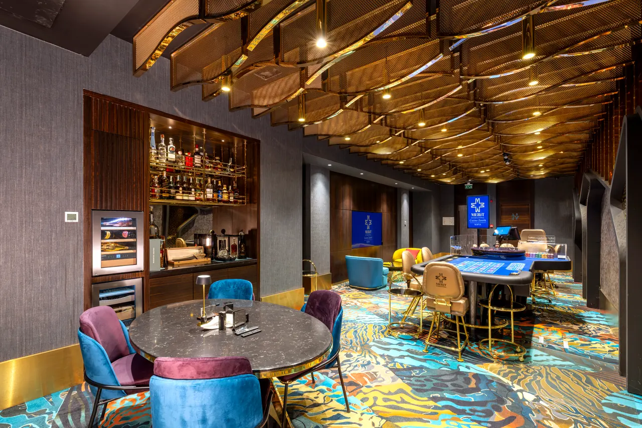 Zenith Casino by Merit International — Oyun salonu: renkli halı ve yuvarlak masalar
